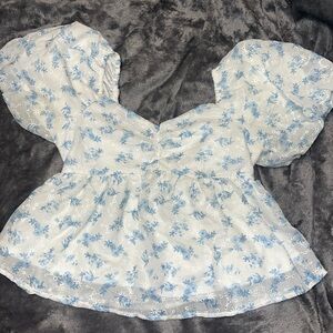 White and blue floral top.